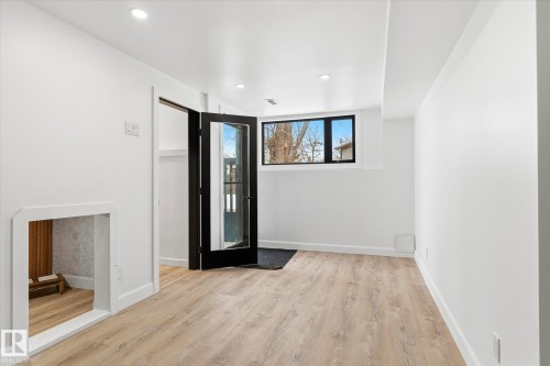 This room features light-colored flooring, recessed lighting, and a window providing natural light - 38 Woodcrest Avenue, St. Albert, AB - Indoor Photo Showing Other Room