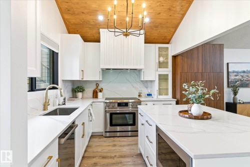 The kitchen features white cabinetry, white countertops, and stainless steel appliances - 38 Woodcrest Avenue, St. Albert, AB - Indoor Photo Showing Kitchen With Upgraded Kitchen