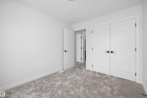 This room features light grey carpet, white walls, and white trim - 236 Kinglet Boulevard Nw, Edmonton, AB - Indoor Photo Showing Other Room