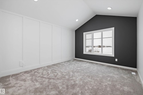 This room features a vaulted ceiling, recessed lighting, and a large window providing natural light - 236 Kinglet Boulevard Nw, Edmonton, AB - Indoor Photo Showing Other Room