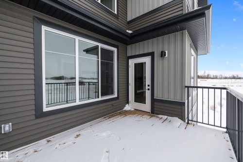 The property features a balcony with a dark railing and a glass paneled door - 236 Kinglet Boulevard Nw, Edmonton, AB - Outdoor With Exterior
