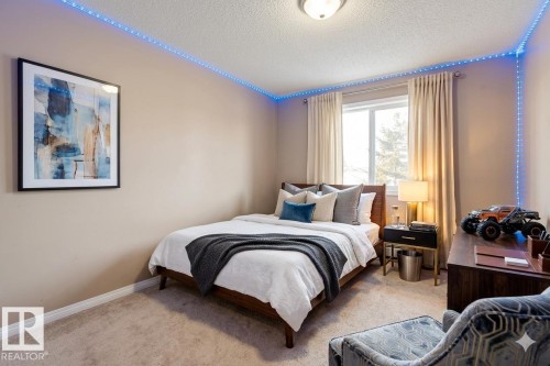 This room features a window with drapes, neutral-toned walls, and carpeting - 224 3425 19 Street Nw, Edmonton, AB - Indoor Photo Showing Bedroom