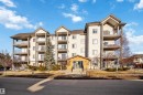 The property features a multi-story building with a light-colored exterior and dark roof, including several balconies with railings - 224 3425 19 Street Nw, Edmonton, AB  - Outdoor With Facade 