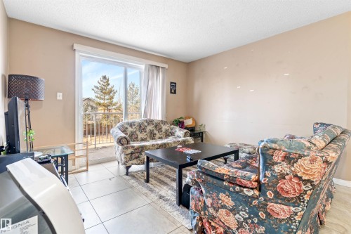 Living area with light-colored walls and tiled flooring - 224 3425 19 Street Nw, Edmonton, AB - Indoor