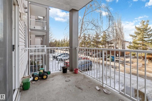 The property features a private balcony with a concrete floor and white metal railings - 224 3425 19 Street Nw, Edmonton, AB - Outdoor With Exterior