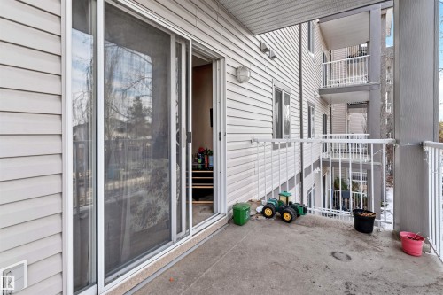 The property features a concrete balcony with white railings, offering views of the surrounding area - 224 3425 19 Street Nw, Edmonton, AB - Outdoor With Exterior