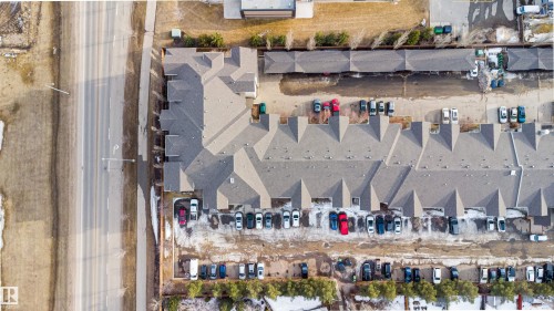 Aerial view of the property, featuring a long, multi-unit building with gabled roofs - 224 3425 19 Street Nw, Edmonton, AB - 