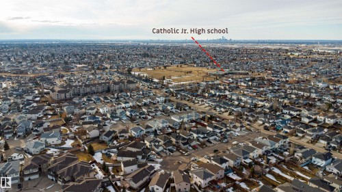 Aerial view of the neighborhood showcasing numerous properties, residential streets, and open land areas - 224 3425 19 Street Nw, Edmonton, AB - Outdoor With View
