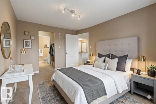 This property features a bedroom with neutral-toned walls and carpeting, offering a versatile aesthetic - 224 3425 19 Street Nw, Edmonton, AB - Indoor Photo Showing Bedroom
