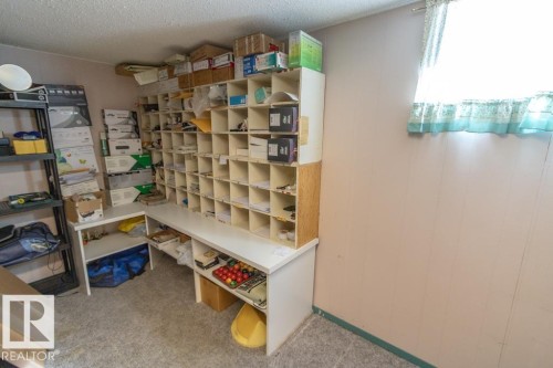 This room features a window with a valance, light-colored walls, and carpeting - 5013 45 St, St. Paul Town, AB - Indoor Photo Showing Other Room