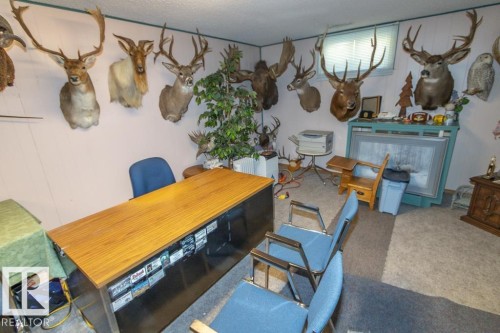 The room features light-colored walls and carpeting, with a window providing natural light - 5013 45 St, St. Paul Town, AB - Indoor Photo Showing Dining Room