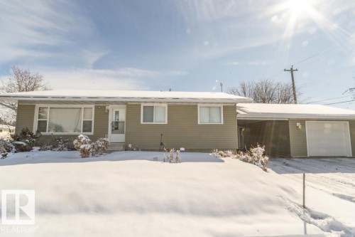 The property features a ranch-style exterior with light green siding and white trim - 5013 45 St, St. Paul Town, AB - Outdoor