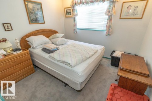 The room features light gray carpet flooring and white walls - 5013 45 St, St. Paul Town, AB - Indoor Photo Showing Bedroom