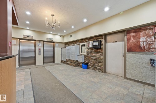 Building entrance area featuring two elevators, mailboxes, and recessed lighting - 209 9710 105 Street Nw, Edmonton, AB - Indoor Photo Showing Other Room