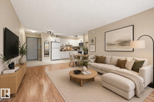 This property features an open-concept living area with a dining space, and a kitchen with white cabinetry and appliances - virtual staging - 209 9710 105 Street Nw, Edmonton, AB - Indoor Photo Showing Living Room