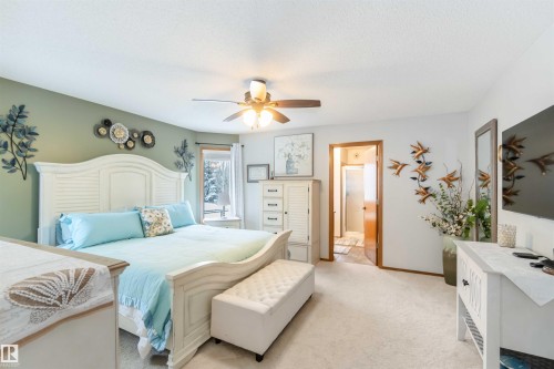 A spacious room featuring carpeting, a ceiling fan, and a view of the outdoors from the window - 61 Linkside Blvd, Spruce Grove, AB - Indoor Photo Showing Bedroom