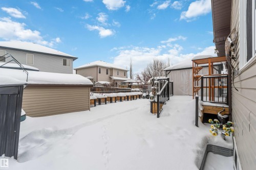 The property features a spacious backyard with a deck and a detached shed - 61 Linkside Blvd, Spruce Grove, AB - Outdoor With Exterior