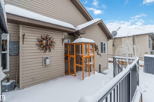 The property features light-colored horizontal siding, a dark-colored balcony railing, and a window on the side of the structure - 61 Linkside Blvd, Spruce Grove, AB - Outdoor With Exterior