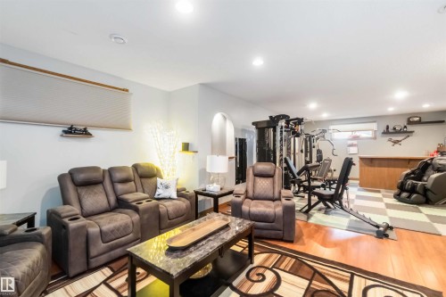 This versatile area features hardwood flooring, recessed lighting, and a window with blinds - 61 Linkside Blvd, Spruce Grove, AB - Indoor
