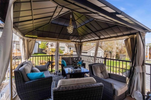 Deck featuring a covered gazebo with a hardtop roof and retractable privacy curtains - 61 Linkside Blvd, Spruce Grove, AB - Outdoor With Deck Patio Veranda With Exterior