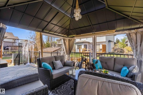 Covered outdoor living space featuring a dark metal gazebo structure - 61 Linkside Blvd, Spruce Grove, AB - Outdoor With Deck Patio Veranda With Exterior
