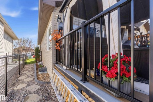Exterior siding with a black metal railing and a stone paver pathway - 61 Linkside Blvd, Spruce Grove, AB - Outdoor With Exterior
