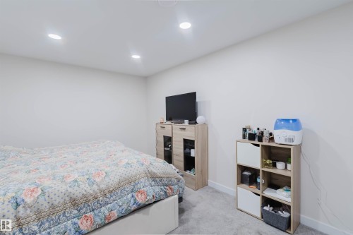 This room features light gray carpet flooring, white walls, and recessed lighting fixtures on the ceiling - 18088 93 Avenue Nw, Edmonton, AB - Indoor Photo Showing Bedroom