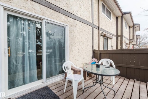 The property features a private outdoor deck with wooden flooring and a brown wooden fence - 18088 93 Avenue Nw, Edmonton, AB - Outdoor With Deck Patio Veranda With Exterior