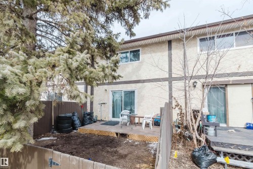 The property features a private fenced yard with a wooden deck - 18088 93 Avenue Nw, Edmonton, AB - Outdoor