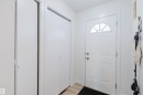 Entryway with a white front door featuring an arched window, a bi-fold closet, and light-colored flooring - 18088 93 Avenue Nw, Edmonton, AB  - Indoor Photo Showing Other Room 