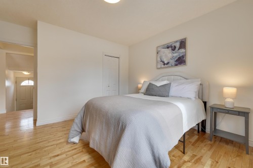 This room features hardwood flooring, white walls, and a white interior door - 10940 71 Avenue, Edmonton, AB - Indoor Photo Showing Bedroom