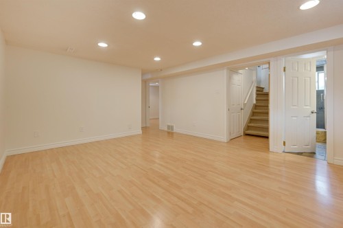 Spacious room featuring light-colored flooring, white walls, and recessed lighting - 10940 71 Avenue, Edmonton, AB - Indoor Photo Showing Other Room