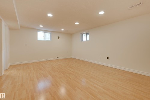 Spacious room featuring light wood flooring, white walls, and recessed lighting - 10940 71 Avenue, Edmonton, AB - Indoor