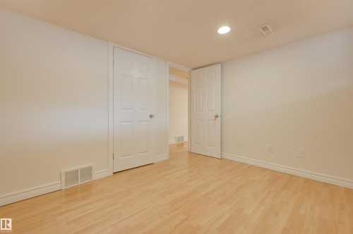 This room features light-colored wood flooring and neutral-toned walls, creating a bright atmosphere - 10940 71 Avenue, Edmonton, AB - Indoor Photo Showing Other Room