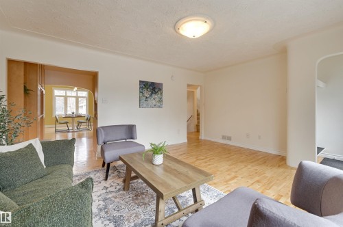 The property features hardwood floors and a light-colored ceiling - 10940 71 Avenue, Edmonton, AB - Indoor Photo Showing Living Room