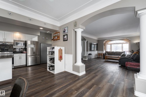 The property features an open layout with rich wood flooring, crown molding, and recessed lighting - 4403 Yeoman Drive, Onoway, AB - Indoor Photo Showing Kitchen