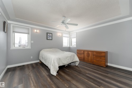 Bedroom featuring dark wood-style flooring, light grey walls, and a ceiling fan - 4403 Yeoman Drive, Onoway, AB - Indoor Photo Showing Bedroom