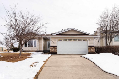 The property features a concrete driveway leading to a two-car garage - 4403 Yeoman Drive, Onoway, AB - Outdoor With Facade