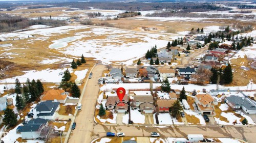 Aerial view of the residential neighborhood, showcasing the property's location within the community and its proximity to open fields - 4403 Yeoman Drive, Onoway, AB - Outdoor With View