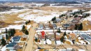 Aerial view of the residential neighborhood, showcasing the property's location within the community and its proximity to open fields - 4403 Yeoman Drive, Onoway, AB  - Outdoor With View 