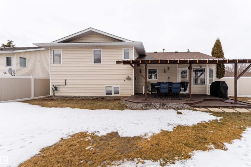 The property features a private deck with a pergola, offering an outdoor dining area - 4403 Yeoman Drive, Onoway, AB - Outdoor