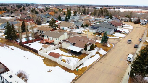 The property is situated within a residential neighborhood featuring paved streets and surrounding homes - 4403 Yeoman Drive, Onoway, AB - Outdoor With View