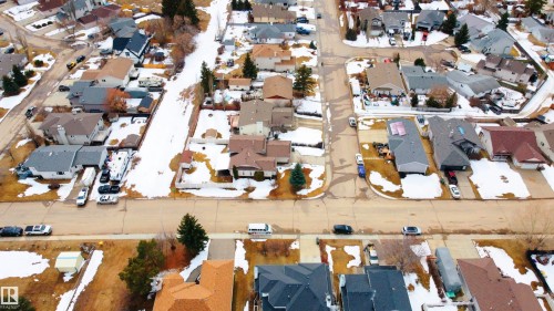 This aerial view showcases a residential area featuring detached properties with varying roof styles and colors - 4403 Yeoman Drive, Onoway, AB - Outdoor With View