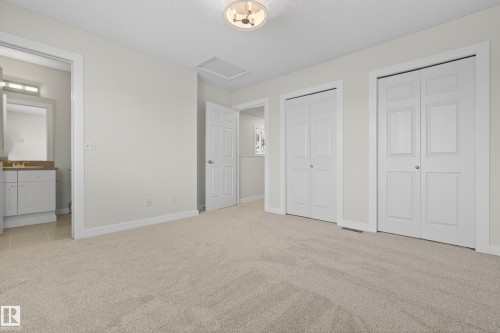 Living area with light-colored carpeting, white walls, and white trim - 9 10909 106 Street, Edmonton, AB - Indoor