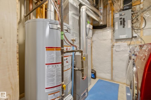 Utility area featuring a water heater, furnace, and electrical panel - 9 10909 106 Street, Edmonton, AB - Indoor Photo Showing Basement