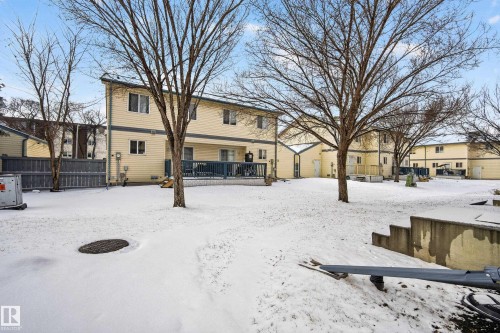 This property features a spacious yard with mature trees and a deck - 9 10909 106 Street, Edmonton, AB - Outdoor