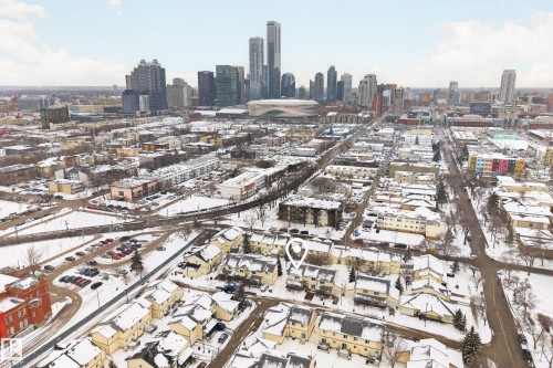 Aerial view showcasing the property within a residential area, featuring a distant city skyline - 9 10909 106 Street, Edmonton, AB - Outdoor With View