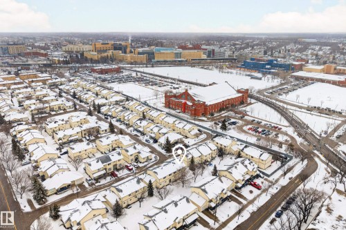Aerial view of the community, showcasing snow-covered residential buildings and surrounding urban landscape - 9 10909 106 Street, Edmonton, AB - Outdoor With View