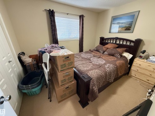 The property features a room with carpeted flooring and a window with blinds and dark curtains - 21113 92A Avenue, Edmonton, AB - Indoor Photo Showing Bedroom