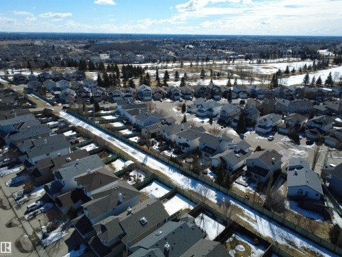 Aerial view of the neighborhood showcasing a collection of homes with various roof styles and surrounding trees - 21113 92A Avenue, Edmonton, AB - Outdoor With View
